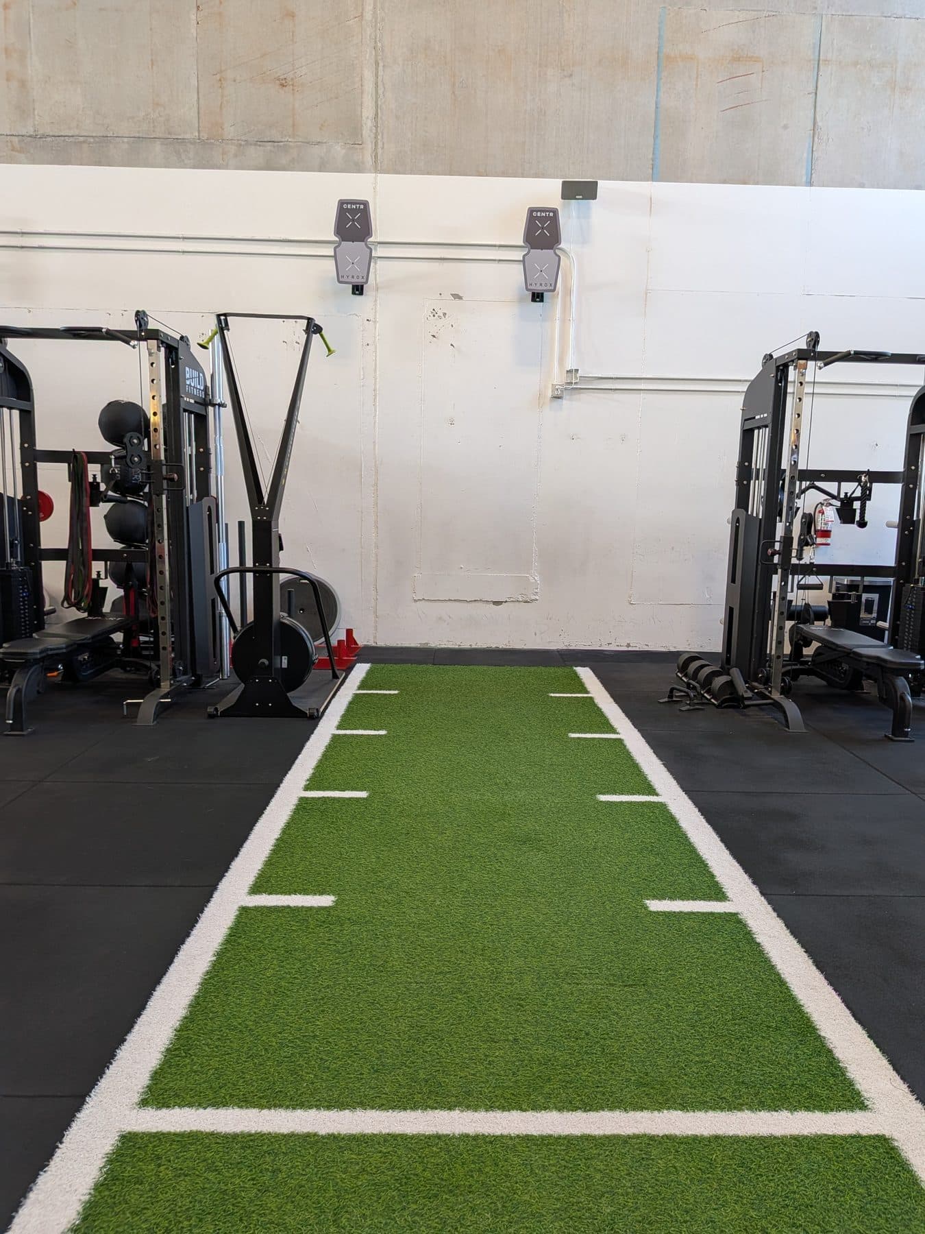 Turf sprint lane between the rigs at Build Fitness in Port Coquitlam